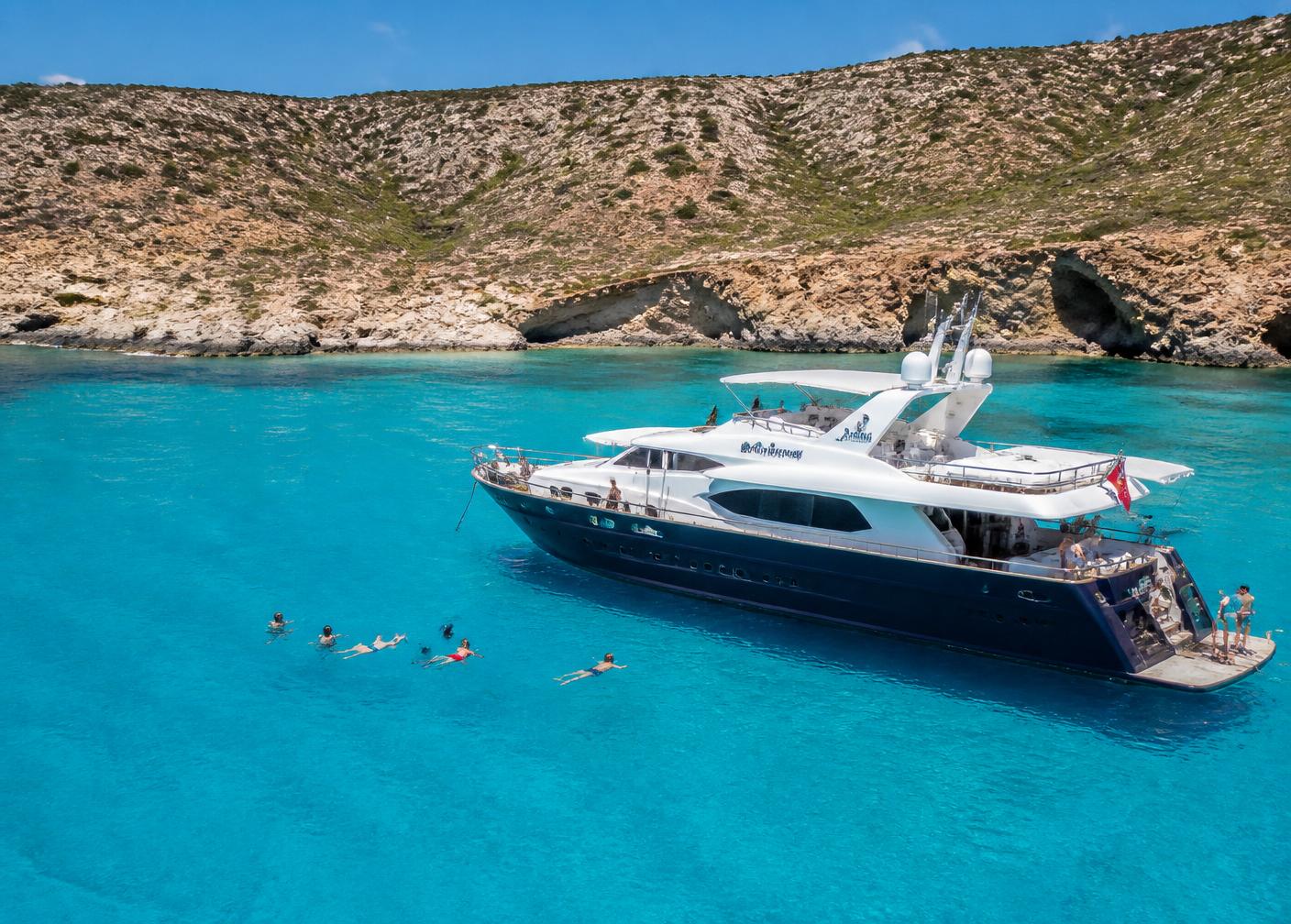 Boat anchored in the bright turquoise water of the Blue Lagoon, Akamas, Cyprus